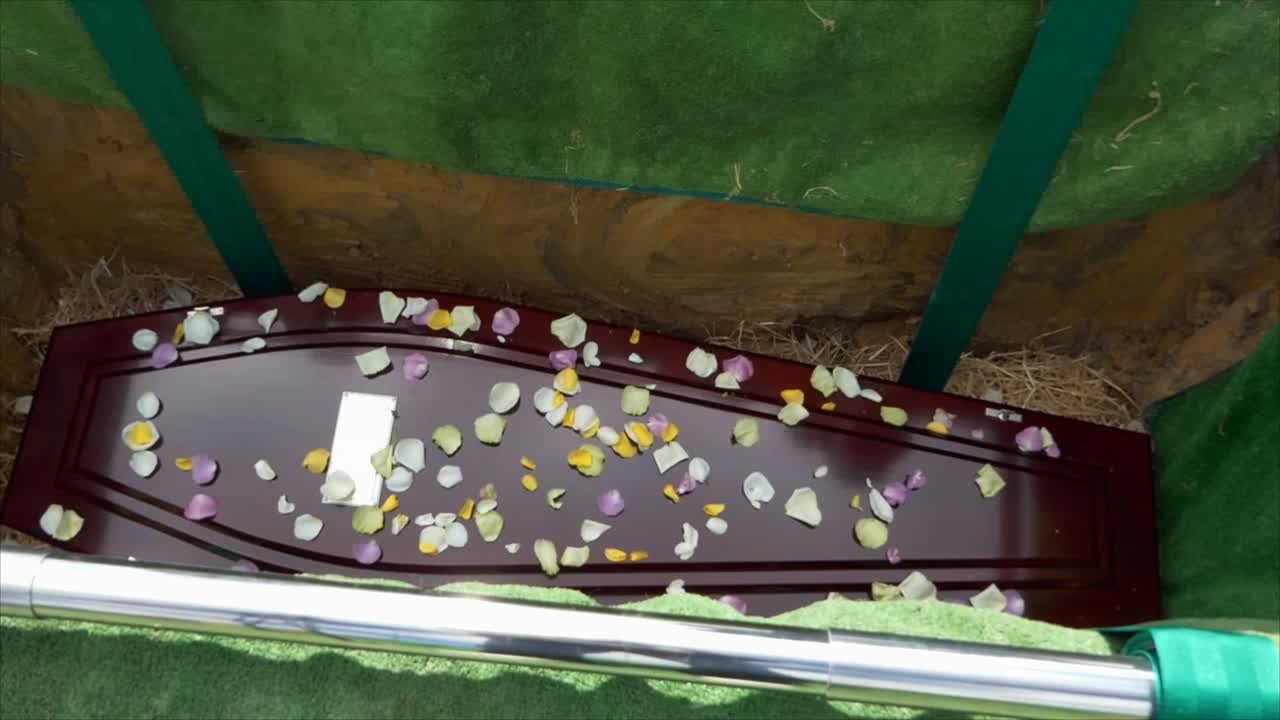 closeup shot of a funeral casket in a hearse or chapel or burial at cemetery