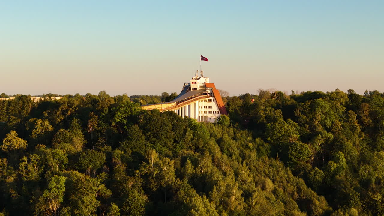 The National Flag Of Latvia Waving Over The Sigulda Bobsleigh, Skeleton, And Luge Track.