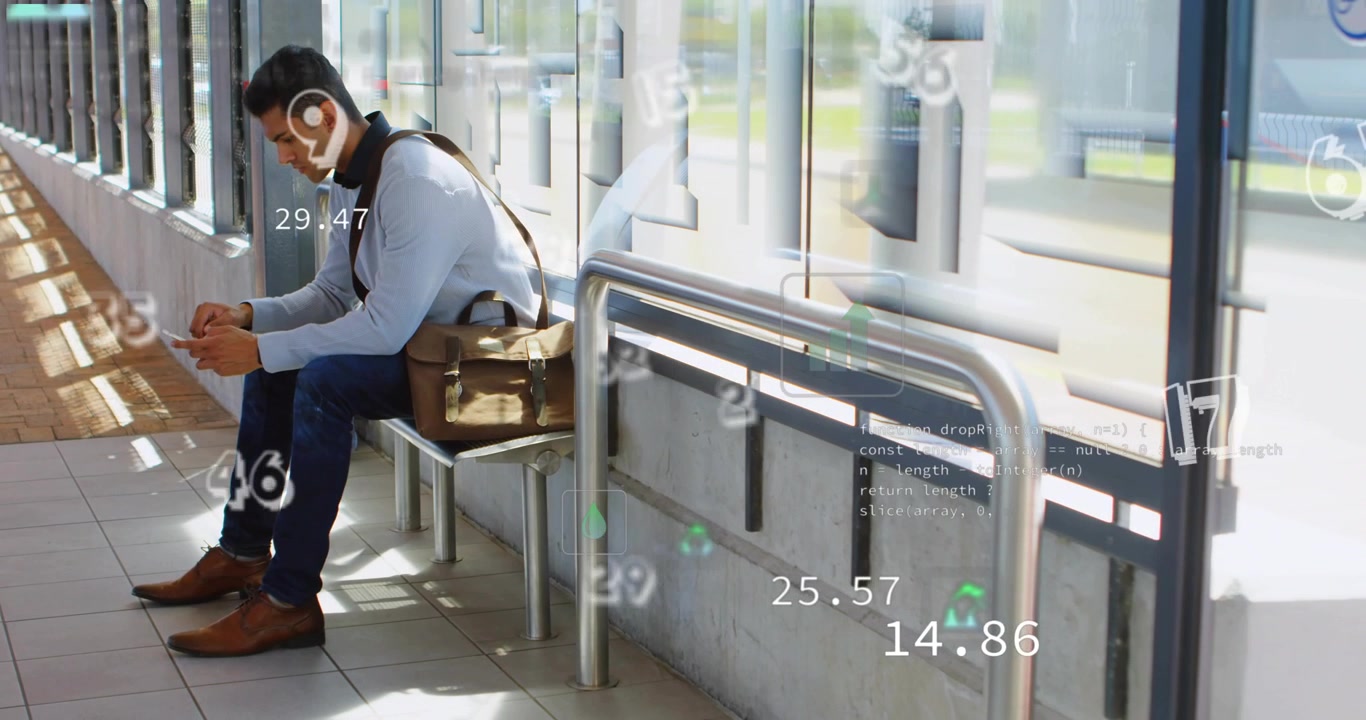 Seated male commuter tapping phone in station, activating AR charts and readouts while waiting