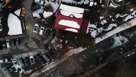 Snow-covered-rooftops-and-streets-of-Kirchberg-township,-aerial-top-down-view