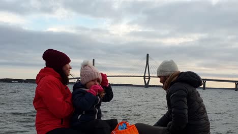 family boat trip with scenic bridge view