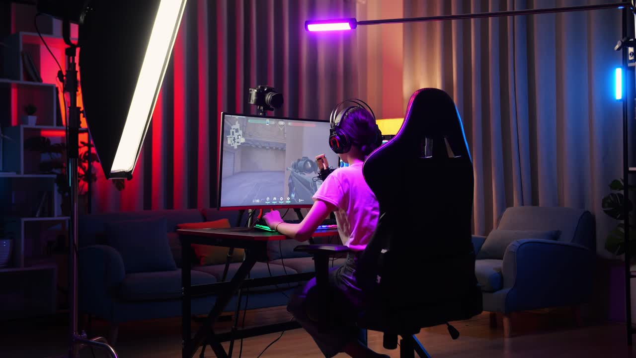 Back View Of Asian Girl Streamer Playing Game Over Network On Personal Computer. Yawning And Sleeping, Live Stream Video Game, Desk Illuminated By Rgb Led Strip Light