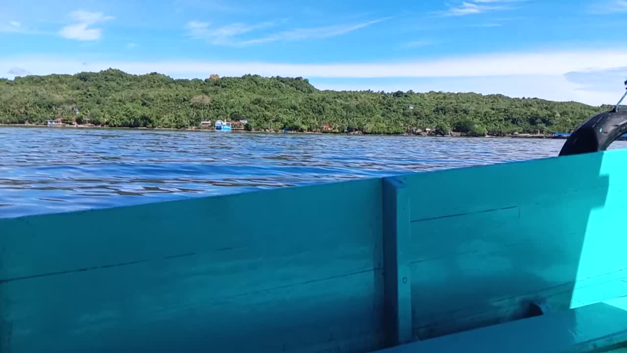 Boat sails in the sea waters on Karampuang Island, West Sulawesi, Indonesia