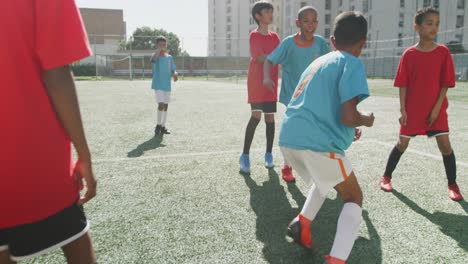 african american kid in blue scoring in a sunny day