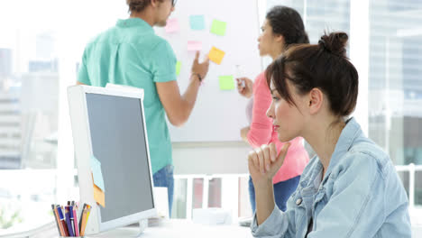 Thoughtful-young-creative-designer-working-on-her-computer-