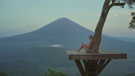 woman reading personal journal with full moon at lahangan sweet viewpoint