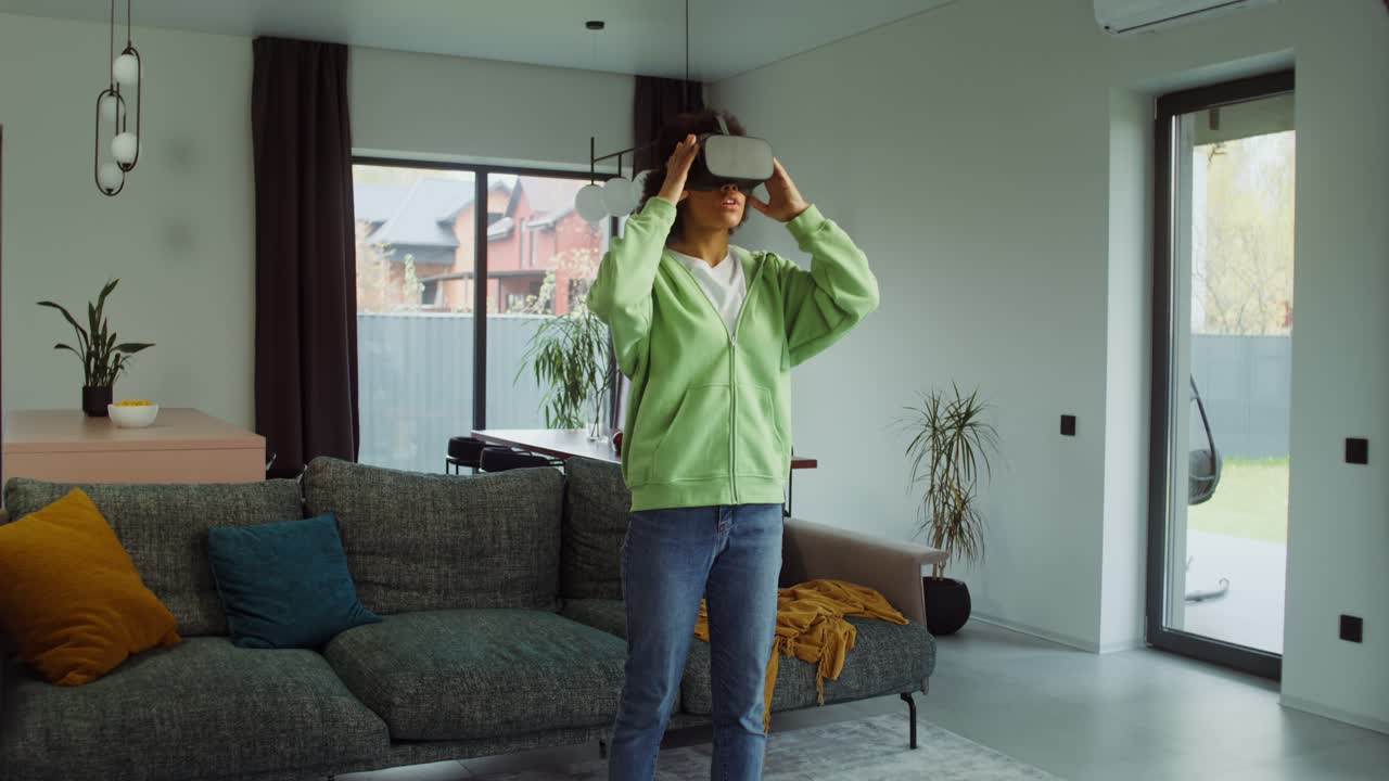 Woman using VR headset in modern living room
