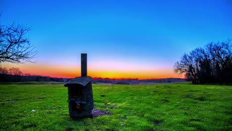 birdhouse in a countryside meadow - golden sunset motion time lapse