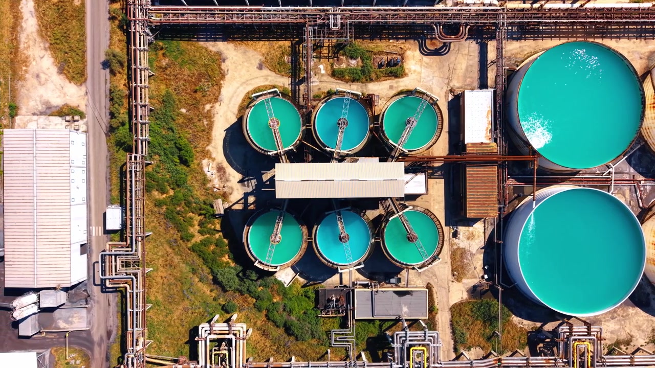 Tanks at a processing site. High view of tanks holding colored liquids at a processing site.
