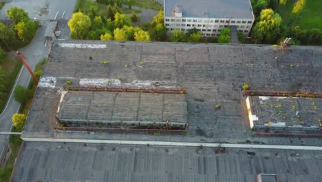 old ruinous factory at sunset. discard old industrial factory exterior with buildings and smokestack
