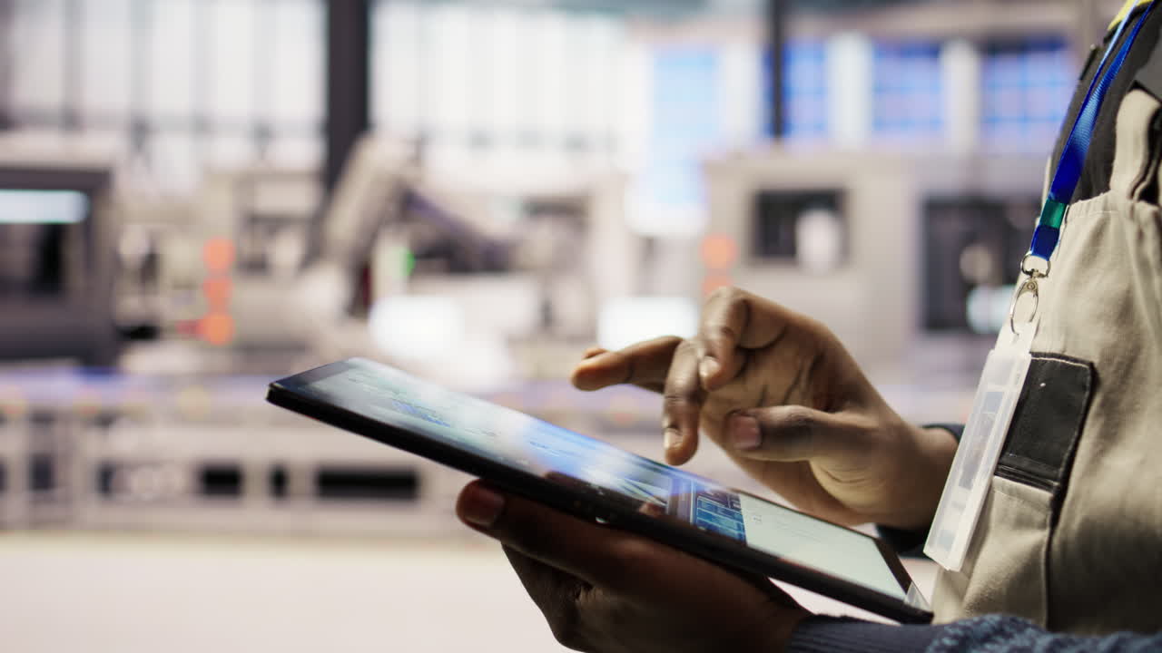 Vertical video Close up of engineer using tablet to design solar panels factory layouts
