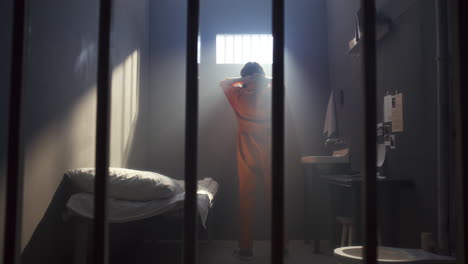 inmate walking around prison cell deep in his thought