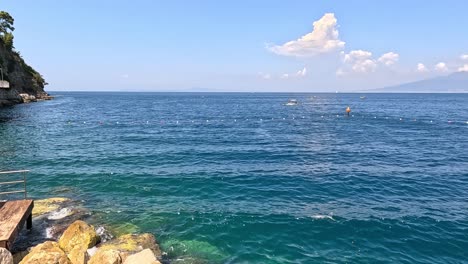 calm sea with distant mountains and clouds