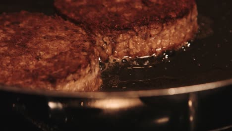 plantbased burgers cooking in pan close up