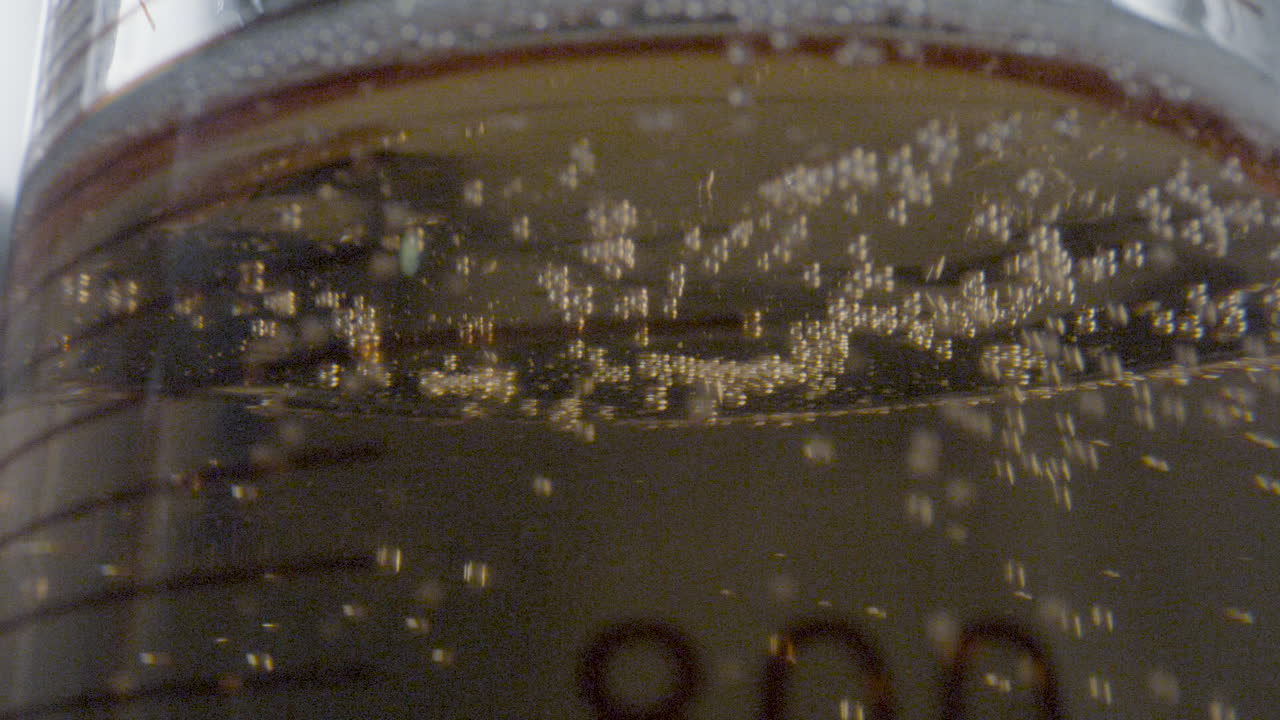 Detailed close-up of a moving gaseous liquid substance inside a laboratory flask.