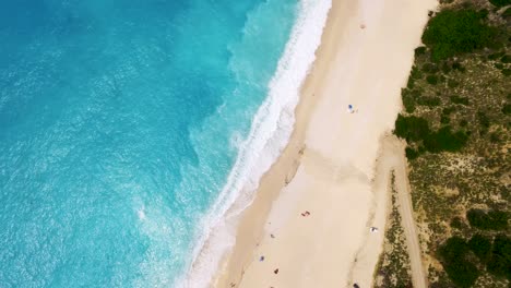 aerial shot of myrtos beach in kefalonia, greece with turquoise waters and white sands