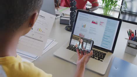 African-american-businesswoman-using-smartphone-for-video-call-with-biracial-business-colleague