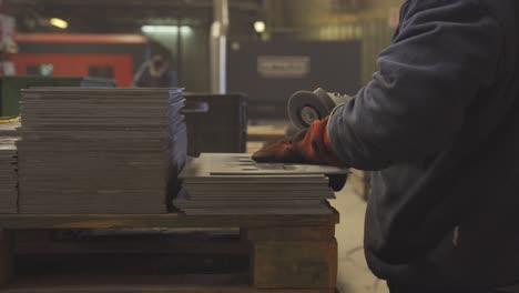 close up worker using grinder in factory in 4k