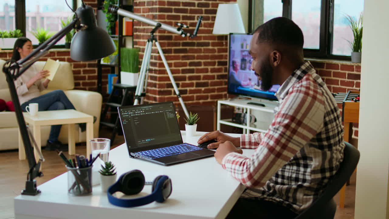 Male programmer developing an app on his laptop and working remotely