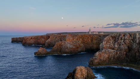 aerial approach towards punta nati lighthouse in menorca, spain