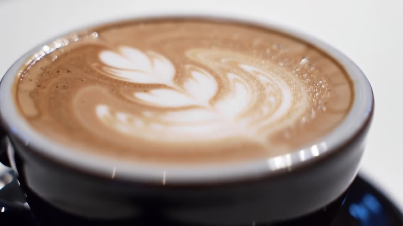 A Close-Up View of Beautifully Crafted Latte Art on Creamy Coffee, Showcasing Elegance and Skill in Each Sip Made for Coffee Enthusiasts, Inviting Relaxation