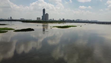 drone flying over river yamuna in shaheen bagh while showing development of high rise building of uttar pradesh boarder