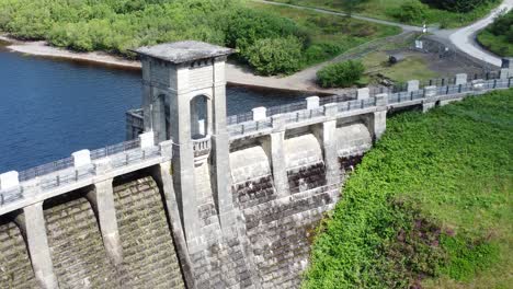 alwen reservoir welsh woodland lake water supply aerial view concrete dam countryside park slow tilt up descend