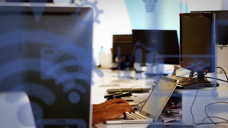 Animation of multiple icons over caucasian man typing on keyboard of laptop in office