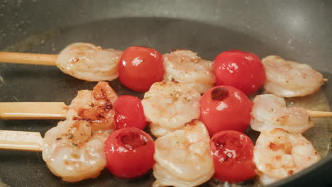 cooking shrimp and tomato skewers