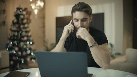 happy man talking on smartphone at home