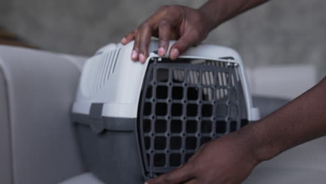 cat getting inside of a carrier