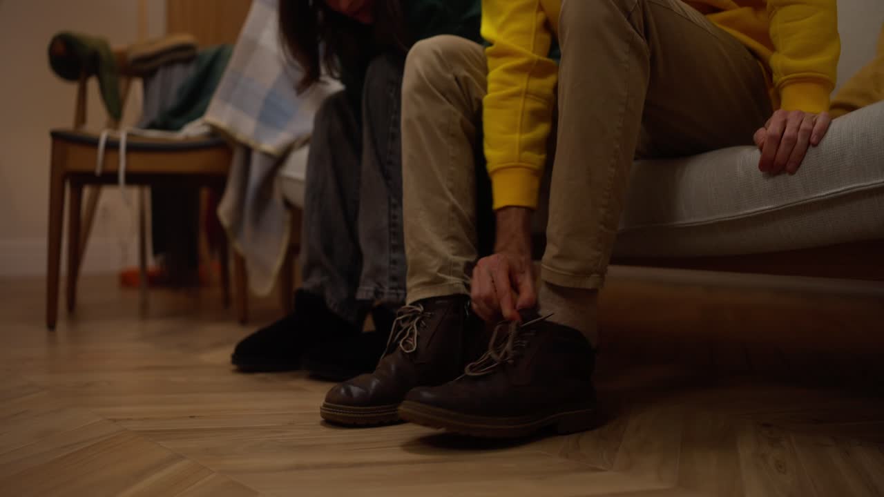 People Putting on Shoes at Home