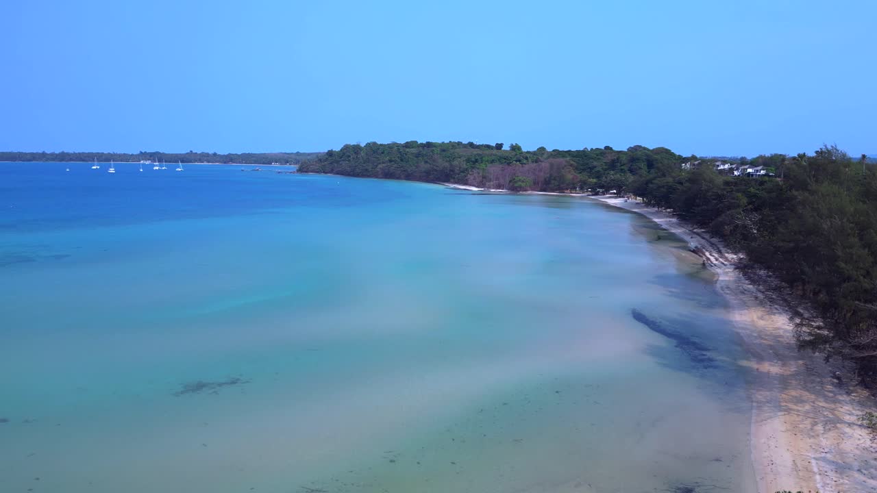 Koh Mak tropical beach meeting turquoise water under blue sky in Thailand. Amazing aerial view flight overflight flyover drone