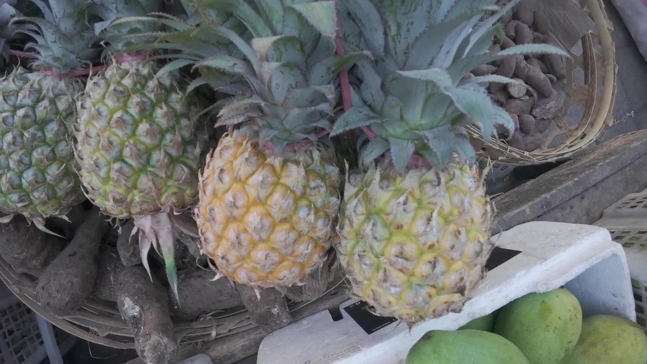 Fresh Pineapples Displayed in Wicker Baskets at a Market