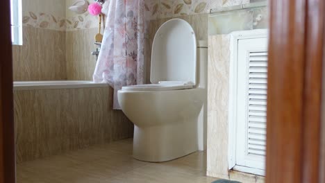 interior of a bathroom with a white toilet and bathtub