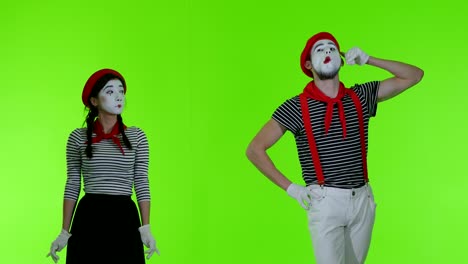 mimes talking on the phone on a green background