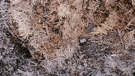 top down aerial footage panning across gigantic piles of various wood materials.