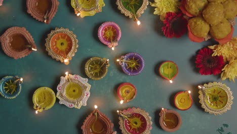 overhead shot of woman lighting diya oil lamps celebrating festival of diwali 1