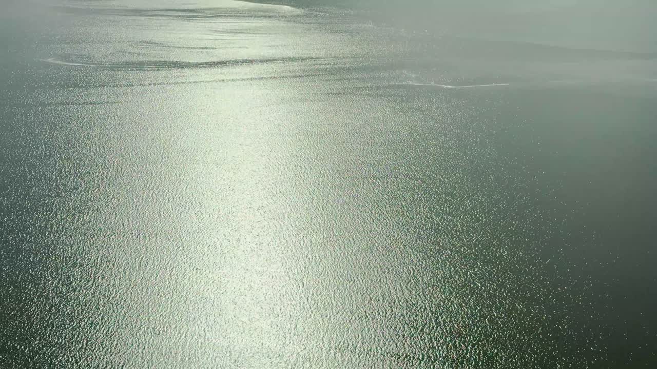 Stunning aerial view of Lake Eyre, revealing its rare and beautiful filling with water. Witness the unique natural phenomenon of the Australian outback from above, showcasing vast, shimmering water.