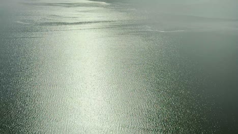 stunning aerial view of lake eyre, revealing its rare and beautiful filling with water. witness the unique natural phenomenon of the australian outback from above, showcasing vast, shimmering water.