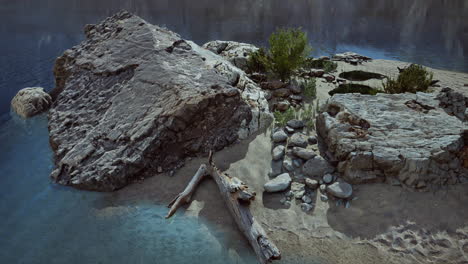 sandy beach in bay surrounded by steep mountains in sunset