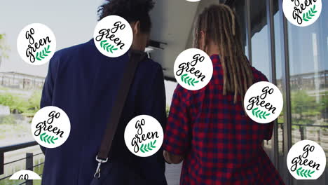 animation of go green text and logos repeated over two diverse male friends walking in street