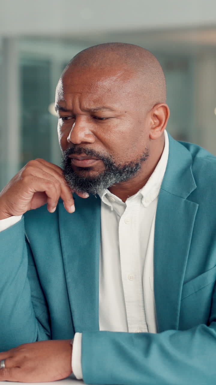 Thoughtful African American Businessman Pondering in Office