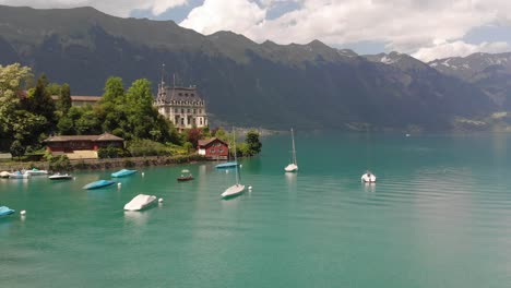 aerial of a sailboats anchored in a alpine lake