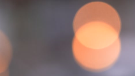 raindrops flow down the glass on the window against the background of ambulance lights. a drop of water falls through the window of a night city. flashing light. blurred background. bokeh. close up