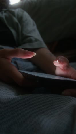 Relaxed Person Using Phone and Listening to Music at Home