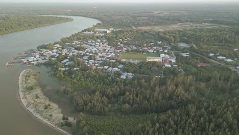 Aerial Drone View During Summer Gerigat Fishing Village,Kabong With, Facing Open Blue Sea, White Sandy Beach,Green Coconut, Palm Trees,And River,Sarawak,Borneo
