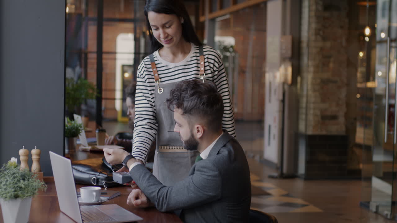 Customer paying with smartwatch in a cafe