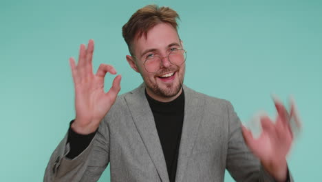 man in suit smiling and giving ok sign