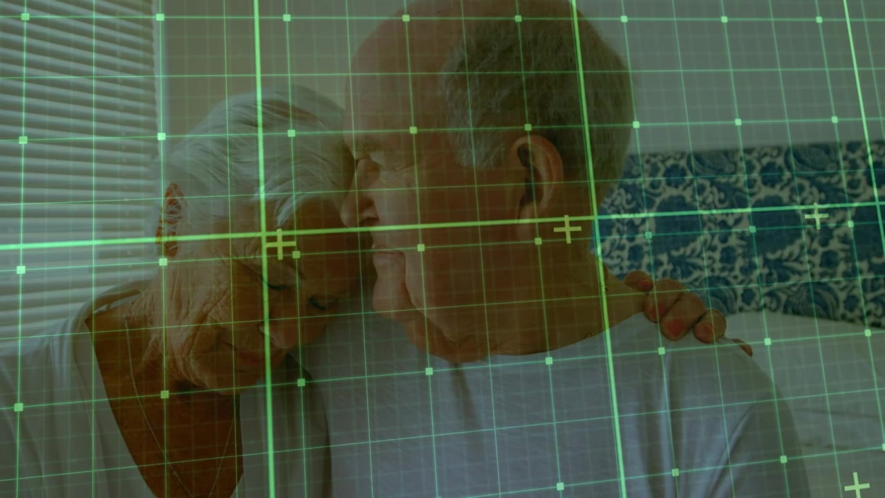 Animation of green net over caucasian senior couple embracing in hospital